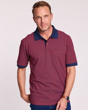 model wearing red polo with blue pattern and blue trim