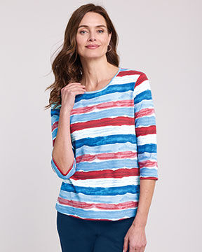 model wearing red, white, and blue 3/4 sleeve shirt, blue jeans
