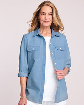 model smiling into camera wearing a denim shirt and white tee and pants
