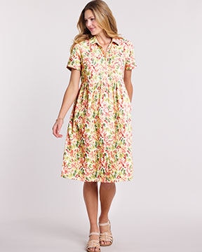 model wearing yellow, red and green floral dress