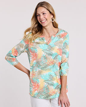 model wearing orange and green patterned top